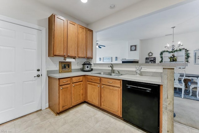 kitchen with kitchen peninsula, pendant lighting, sink, ceiling fan with notable chandelier, and black dishwasher