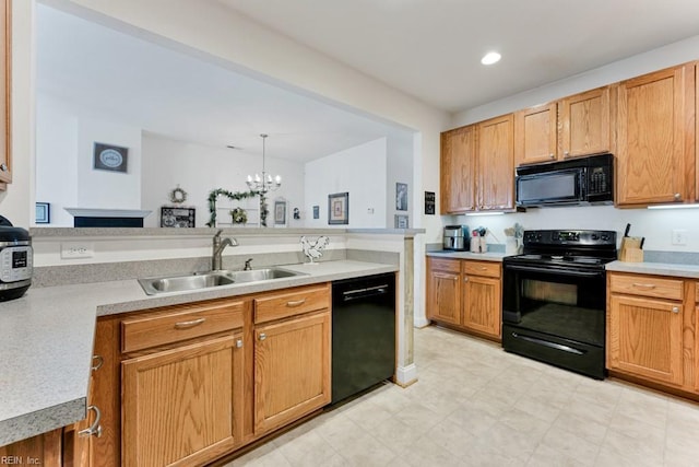 kitchen featuring black appliances, sink, hanging light fixtures, kitchen peninsula, and a chandelier