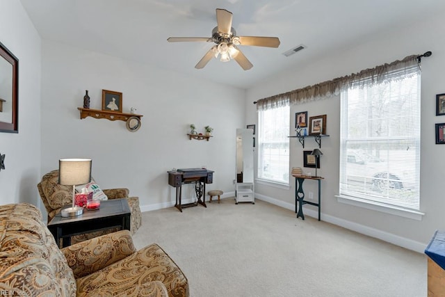 sitting room featuring ceiling fan and light colored carpet