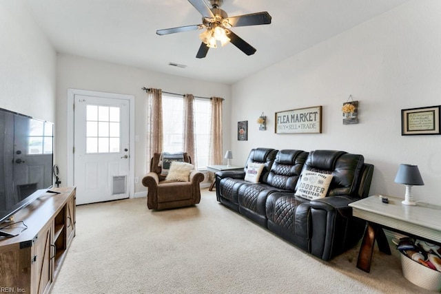 carpeted living room with ceiling fan