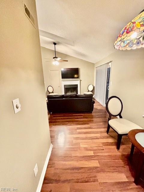 hall featuring vaulted ceiling and light hardwood / wood-style flooring