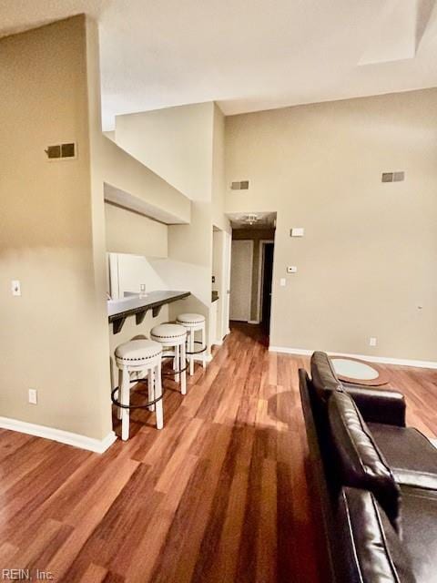 interior space featuring hardwood / wood-style flooring and high vaulted ceiling