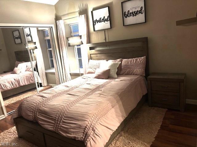 bedroom featuring dark wood-type flooring and a closet