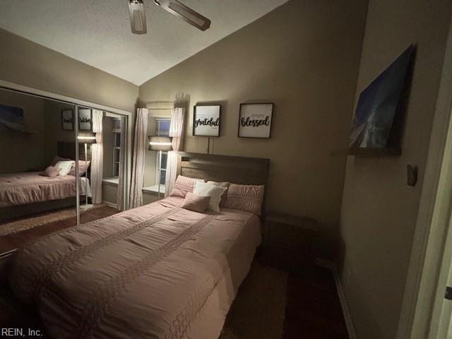 bedroom with ceiling fan, vaulted ceiling, and a closet