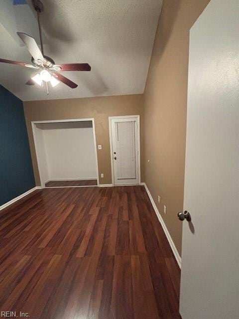 empty room featuring ceiling fan and dark hardwood / wood-style flooring