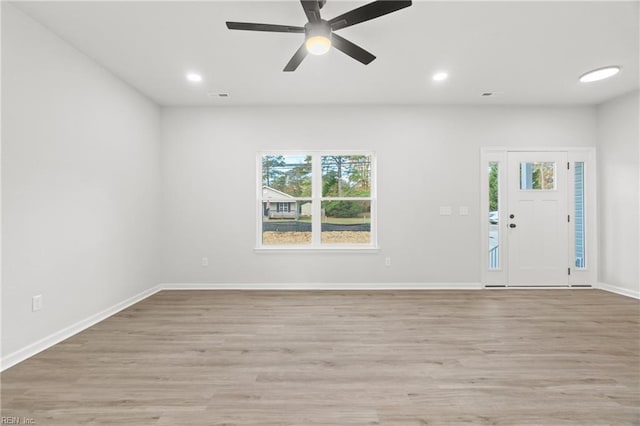 foyer with ceiling fan and light hardwood / wood-style flooring