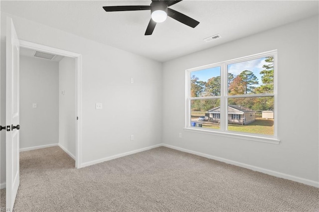 carpeted empty room featuring ceiling fan