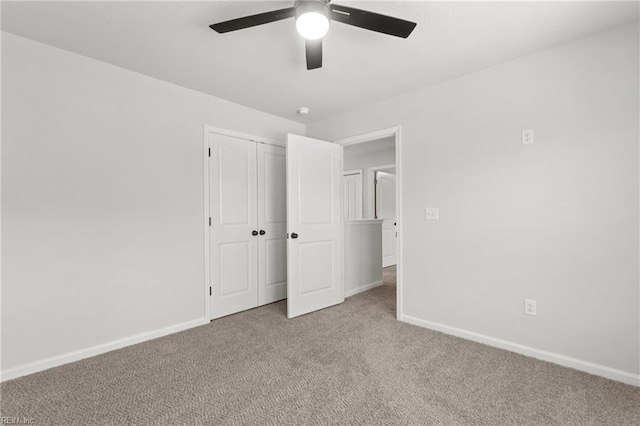 unfurnished bedroom with light colored carpet, ceiling fan, and a closet