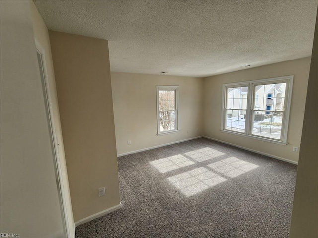 carpeted spare room featuring a textured ceiling