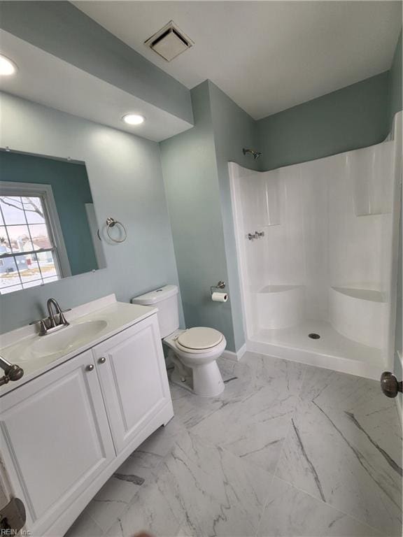 bathroom with vanity, toilet, and walk in shower