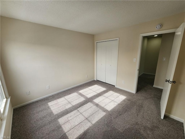 unfurnished bedroom with a closet, light carpet, and a textured ceiling