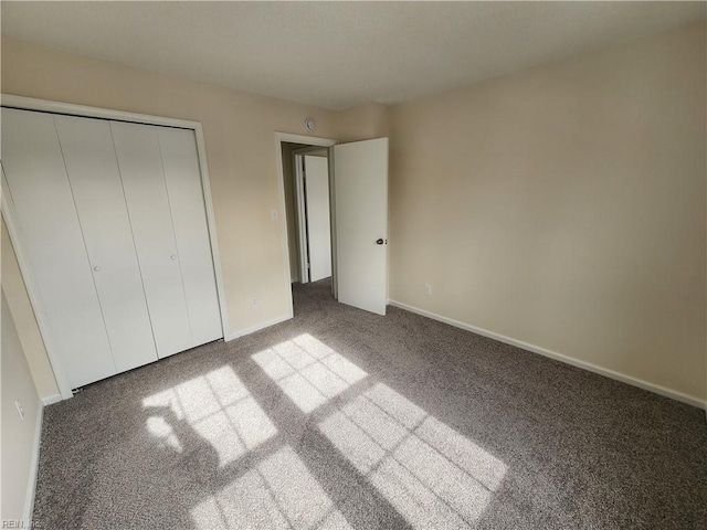 unfurnished bedroom with carpet floors and a closet