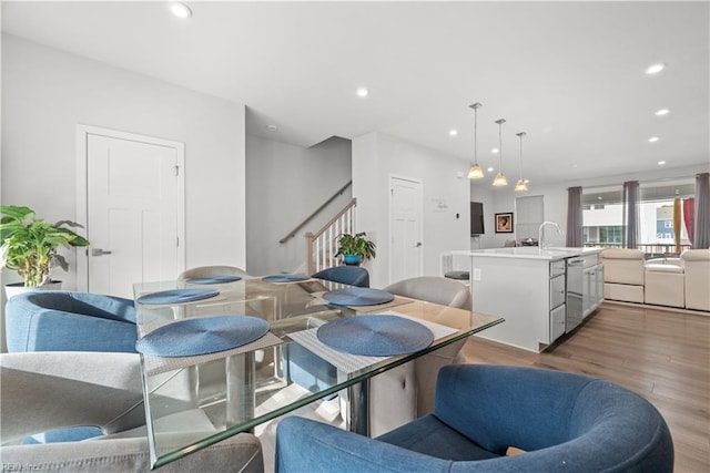 dining space with sink and hardwood / wood-style floors