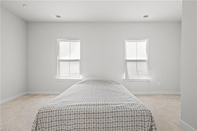 bedroom featuring light carpet