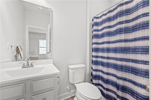 bathroom with vanity, toilet, and a shower with shower curtain