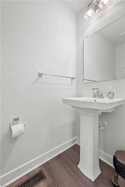 bathroom featuring sink and hardwood / wood-style floors