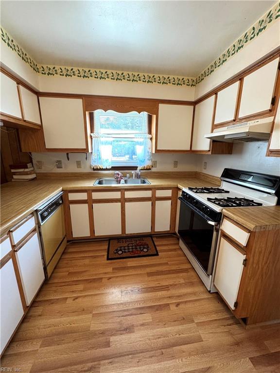 kitchen featuring white cabinetry, dishwasher, sink, light hardwood / wood-style floors, and white gas range oven