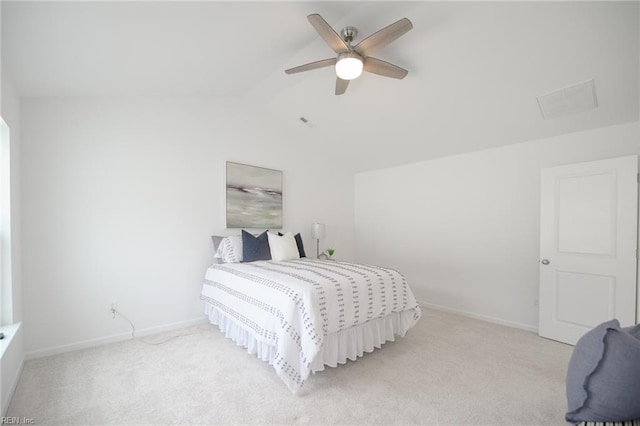 bedroom featuring vaulted ceiling, light carpet, and ceiling fan