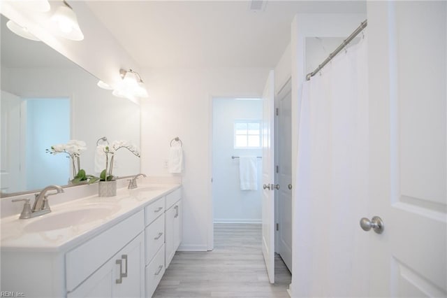 bathroom with vanity and hardwood / wood-style floors