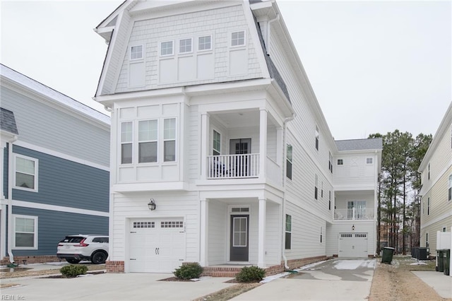 view of front of property with cooling unit and a garage