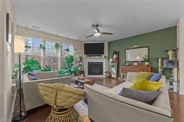 living room featuring dark hardwood / wood-style floors and ceiling fan