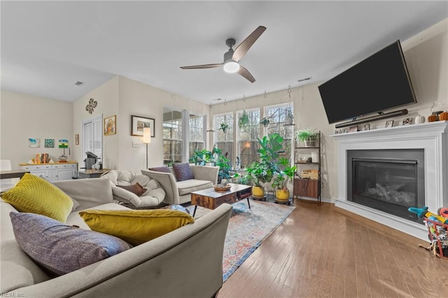 living room with hardwood / wood-style flooring and ceiling fan