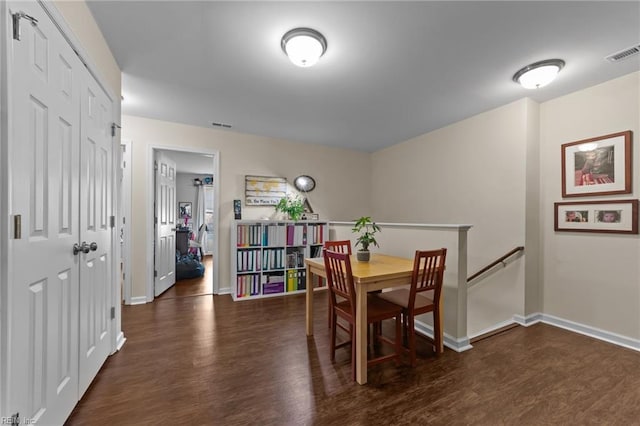 dining area with dark hardwood / wood-style flooring