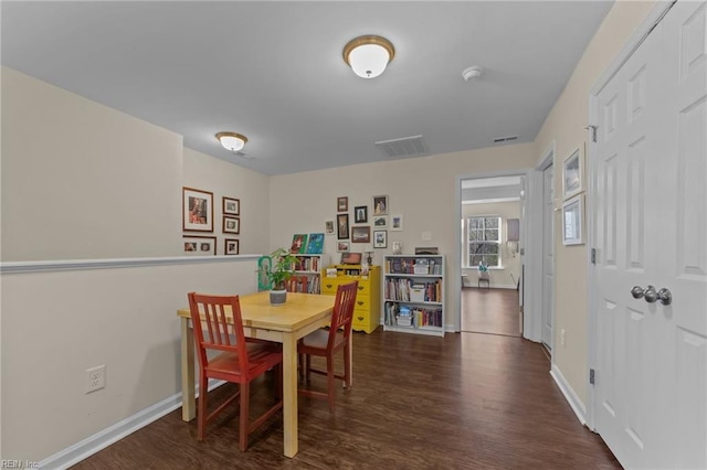 dining room with dark hardwood / wood-style flooring