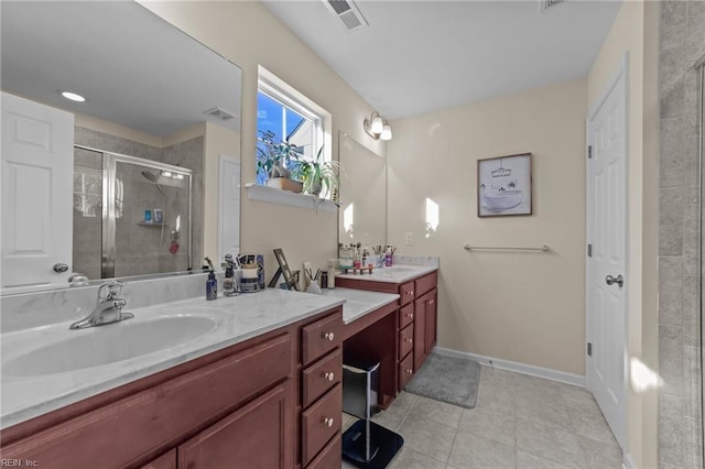 bathroom featuring tile patterned flooring, vanity, and a shower with shower door