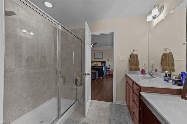 bathroom featuring an enclosed shower, vanity, and tile patterned floors