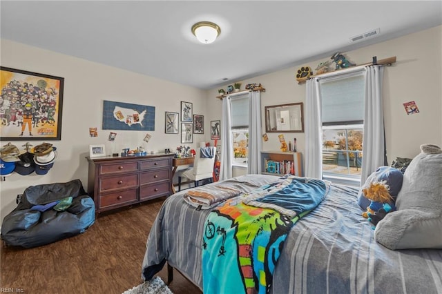 bedroom with dark hardwood / wood-style flooring