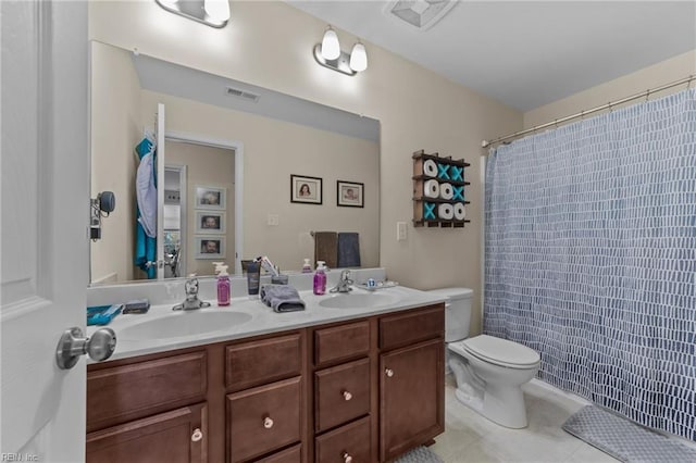 bathroom with vanity, toilet, and tile patterned flooring