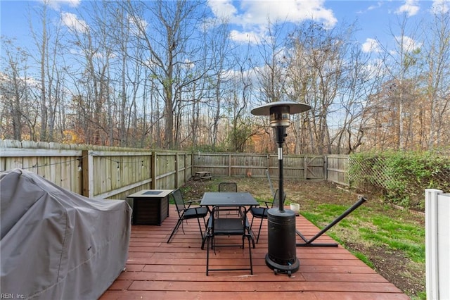 wooden terrace with a grill