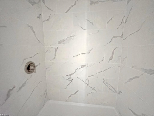 bathroom with a tile shower