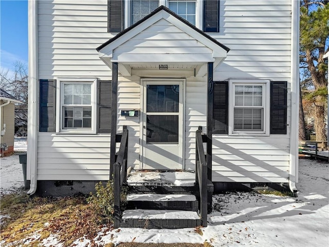 view of snow covered property entrance