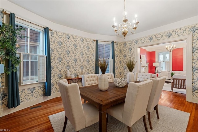 dining space with an inviting chandelier and wood-type flooring