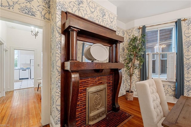 sitting room with hardwood / wood-style flooring and a fireplace