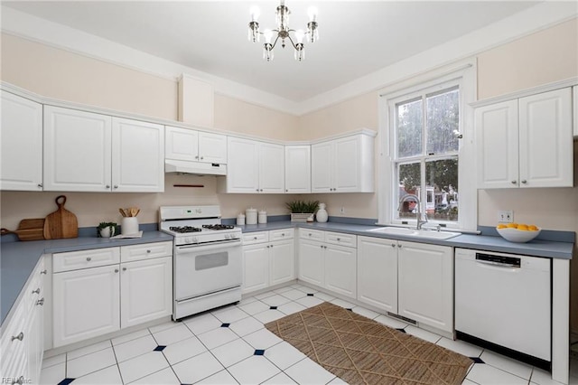 kitchen with sink, white appliances, a chandelier, and white cabinets