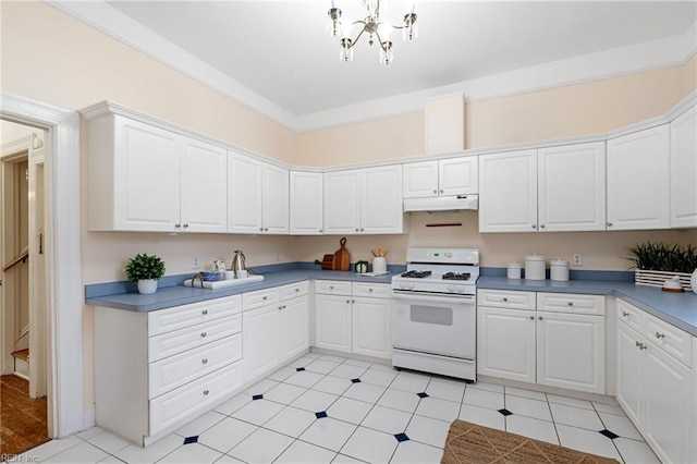 kitchen with white cabinetry, ornamental molding, white range with gas stovetop, and light tile patterned floors