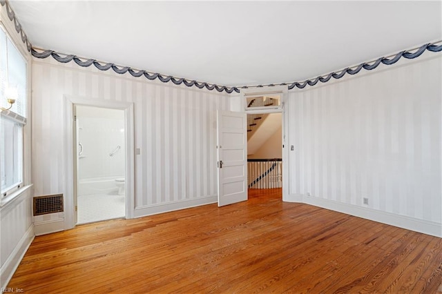 spare room with hardwood / wood-style floors