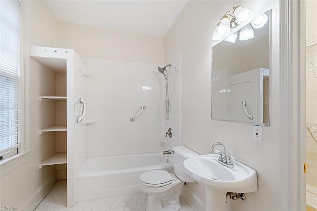 full bathroom featuring toilet, sink, tiled shower / bath combo, and tile patterned flooring