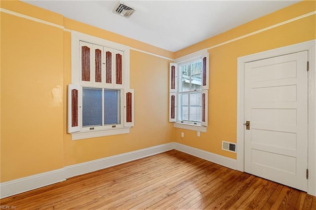 spare room with hardwood / wood-style floors