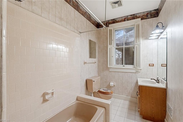 bathroom featuring vanity, tile patterned floors, and toilet