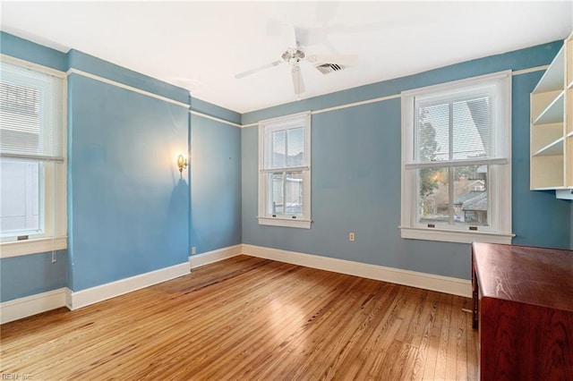 spare room with ceiling fan and light hardwood / wood-style flooring