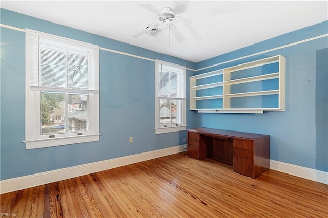 unfurnished office featuring ceiling fan and light wood-type flooring