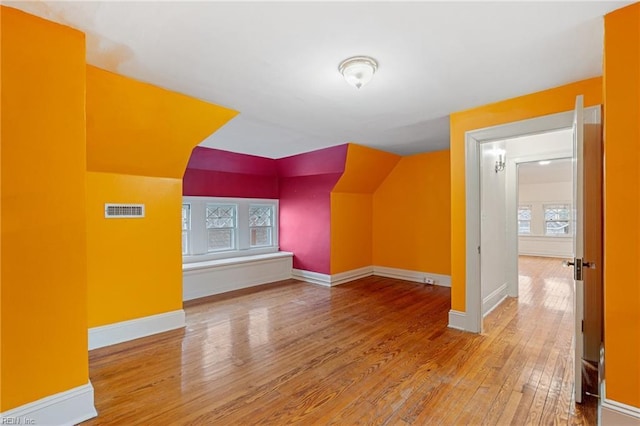 bonus room featuring hardwood / wood-style flooring and lofted ceiling