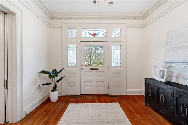 foyer entrance with hardwood / wood-style flooring and ornamental molding