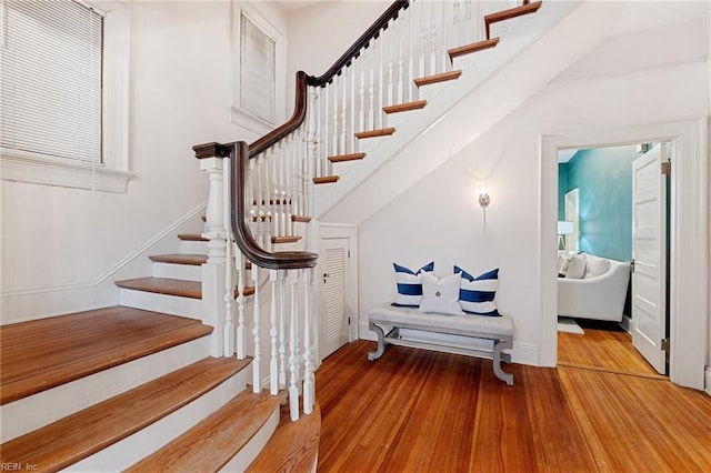 stairway with hardwood / wood-style floors