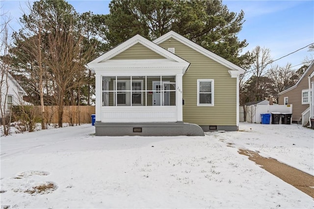 view of front of home featuring a sunroom