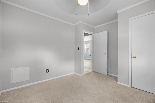 interior space with ornamental molding, light colored carpet, and ceiling fan